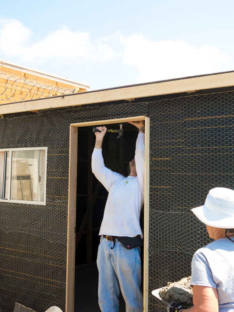 Door top fitting while mud is heading for the exterior walls